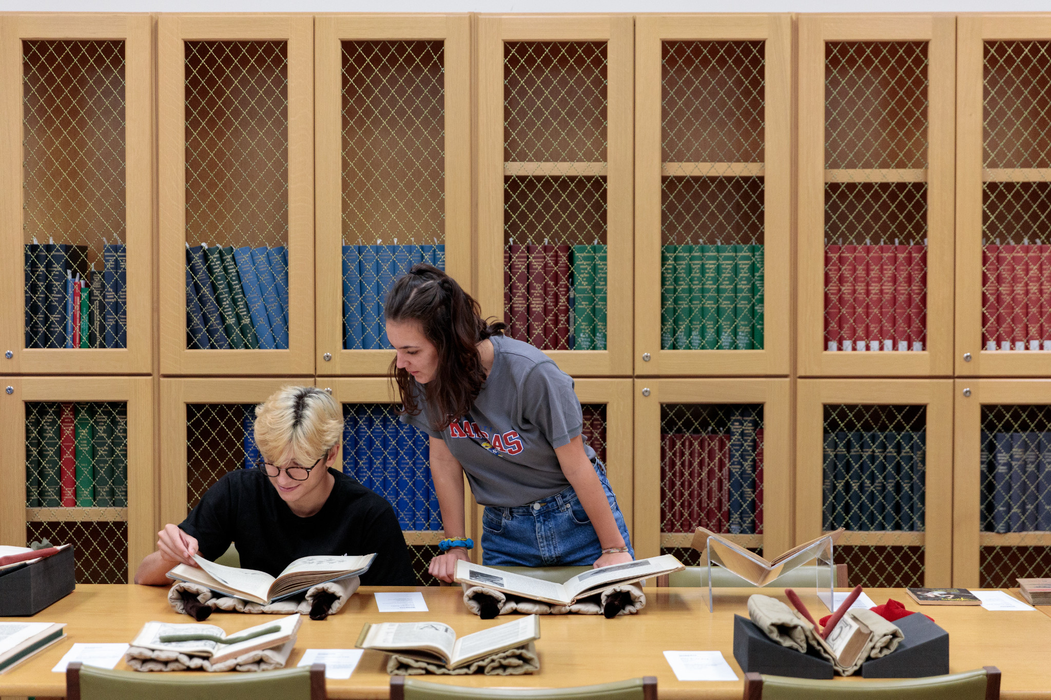 students research texts in the research library